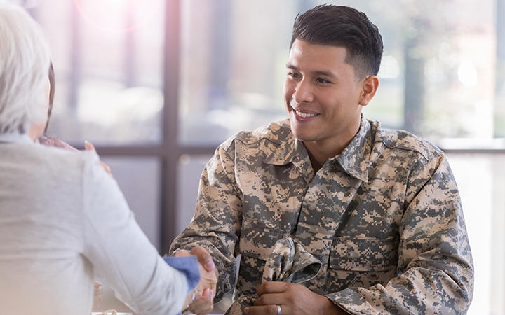 Miltary handshake over a flag